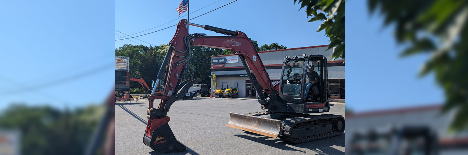 Jesey Rents excavator on dirt hill at job site